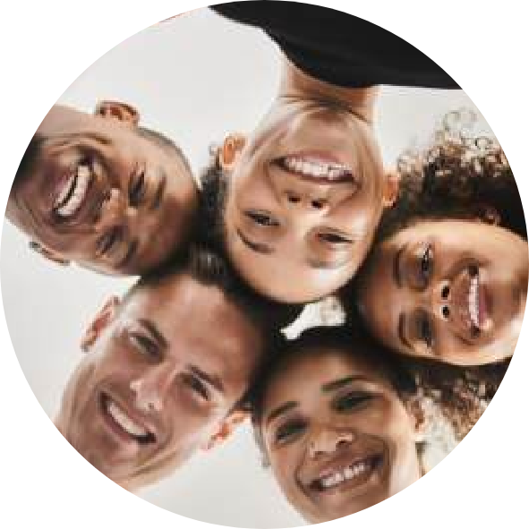 A diverse group of smiling gym members looking down into the camera in a circle huddle at Influence Boutique Fitness.